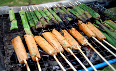 Close up barbecue grills and Thai Steamed fish in banana leaves, with at barbecue party.