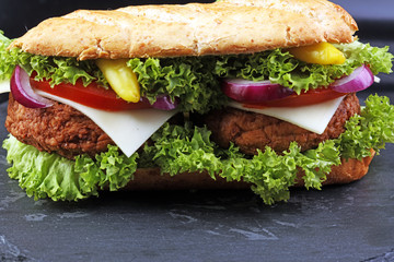 Tasty grilled prawn and beef burger with lettuce and tomato