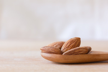 almond on wooden spoon