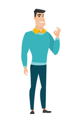 Smiling businessman showing ok sign.
