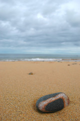 Fototapeta na wymiar Close up of a banded pebble on beach.