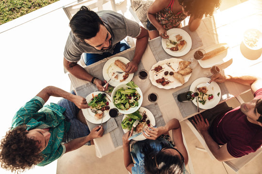 Friends having meal outdoors