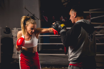 Girl Training on mitts with her boxing instructor