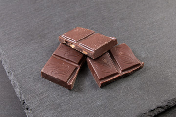 Chocolate pieces on dark background