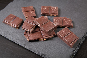 Chocolate pieces on dark background