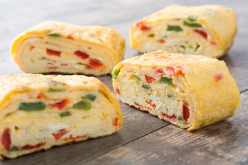 Traditional tamagoyaki Japanese omelette on wooden background