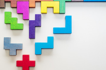 Abstract Background. Different colorful shapes wooden blocks on beige background background. Geometric shapes in different colors. Concept of creative, logical thinking or problem solving. Copy space