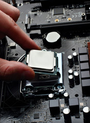 Plug in CPU microprocessor to motherboard socket. Technological background.Concept computers harware