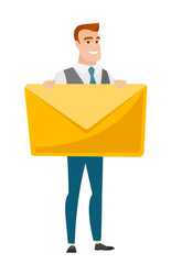 Smiling businessman holding a big envelope.