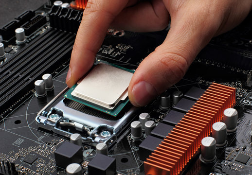 Plug in CPU microprocessor to motherboard socket. Technological background.Concept computers harware