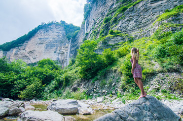 Girl enjoying huge Kinchkha Waterfall view near Kutaisi, Georgia