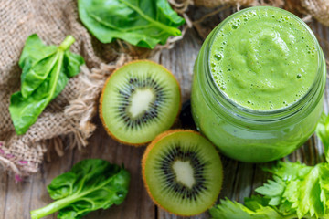 Naklejka na ściany i meble Healthy smoothie spinach, banana and kiwi in glass jar.
