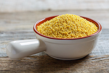 Organic dried millet in a ceramic bowl.