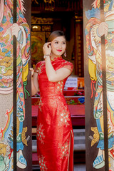 Chinese woman in red dress traditional in chinese temple,happy