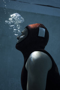 Diver holding breath in pool 