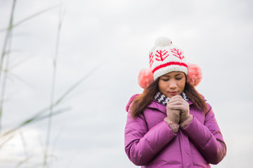 Young woman was playing in a field of flowers in the winter air.