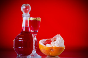 sweet grapefruit alcoholic cordial in the decanter with a glass