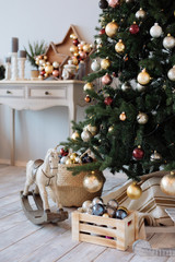 fir-tree with Christmas decorations in a white bedroom
