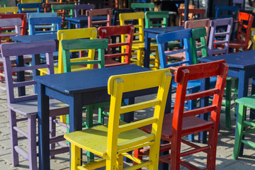 Fototapeta na wymiar Colored wooden chairs in Kas, Antalya