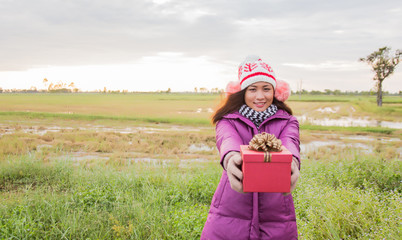 Happy young woman with gift in hands. Christmas and winter conce