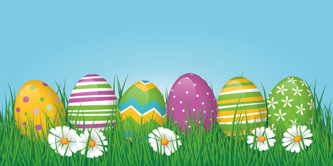 Easter border or banner with eggs in grass and copy space above