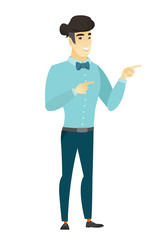 Young asian businessman pointing to the side.