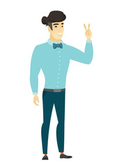 Asian businessman showing the victory gesture.