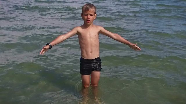Little boy falling into water, slow motion
