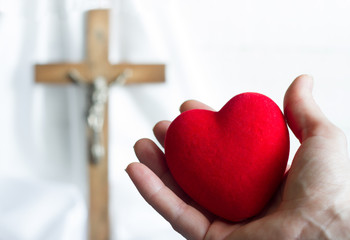 Giving heart to Jesus abstract concept with easter cross on a white background

