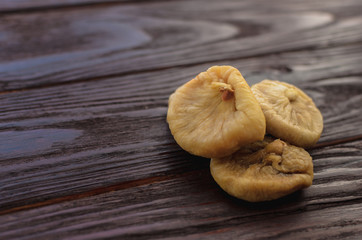 Dry figs on the wooden table dark textural