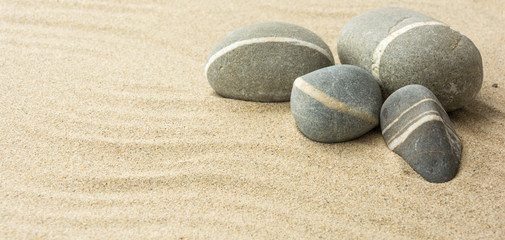 Fototapeta na wymiar Sand and stones. Beach composition with copy space.