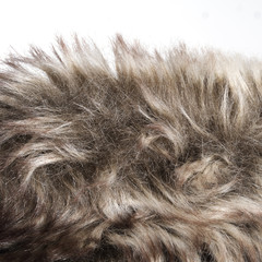Fake fur detail with edge, against white background.