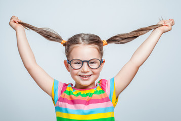 funny cute little girl playing with her hair