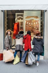 Happy female group of friends doing shopping together