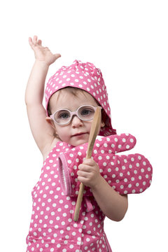 Small children, with a wooden spoon and cook costume
