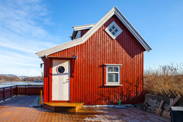 Red wooden cabin on the island, Norwegian style