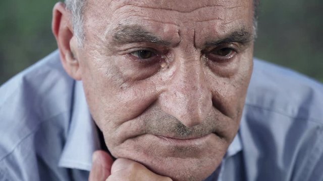 widower reflects on life by holding the chin with his hand