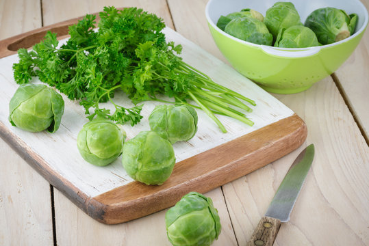 Organic raw brussels sprouts and parsley.