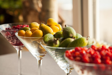 Fresh fruits perfect source of vitamins. Pomegranate, feijoa, red berry and kumquat healthy food for all seasons of the year.