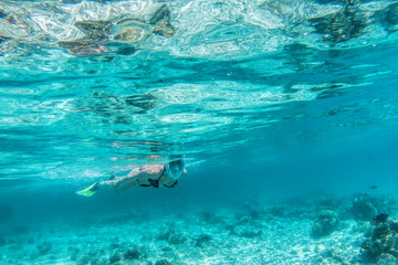 Fototapeta na wymiar Woman snorkeling underwater in Indian Ocean, Maldives