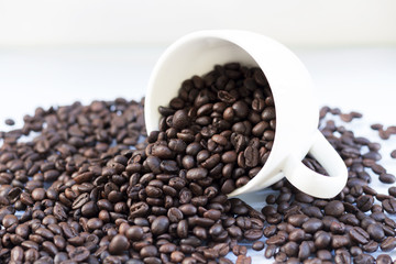 Coffee beans in coffee cup isolated on white