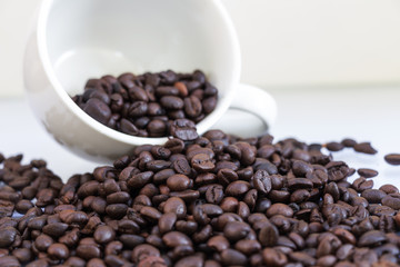 Coffee beans in coffee cup isolated on white