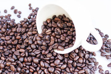 Coffee beans in coffee cup isolated on white