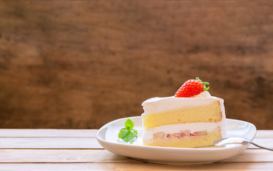 cake with cream and strawberries on a dark wood background. tinting.