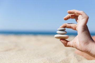Man who holds sea shingle
