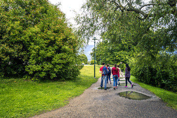 Group of young people are walking in the park, Stockholm, Sweden