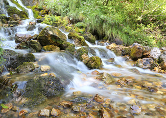 mountain stream with water that seems in motion photographed wit