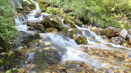 mountain stream with water that seems in motion photographed wit