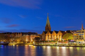 Fototapeta premium Cityscape of night old town over the Weser river