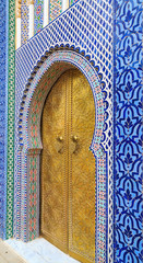 Entrance door with mosiac and brass door at the Royal palace in Fez